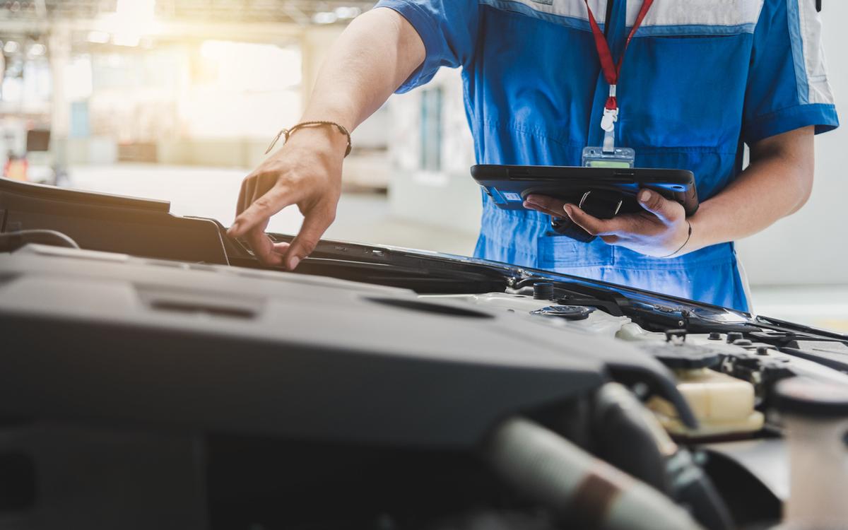 Vehicle appraiser inspects a car during an actual cash value assessment.