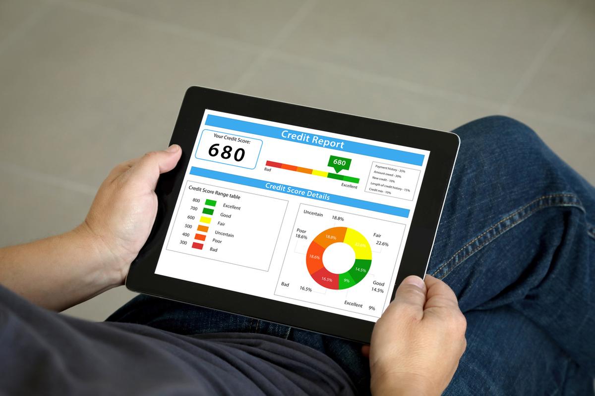 Person reviewing a credit report on a tablet.